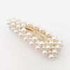Pearl hair clip with gold accents, elegant accessory for wedding, bridal, or formal hairstyle. Handmade jewelry piece featuring a cluster of lustrous white pearls and a gold clasp.