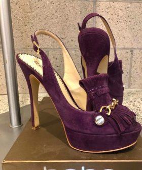 Suede burgundy high-heeled platform shoes with decorative tassels and gold accents, elegant and stylish for special occasions.