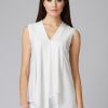Elegant white sleeveless top with a V-neckline, perfect for sophisticated fashion looks and women's stylish casual or office wear.