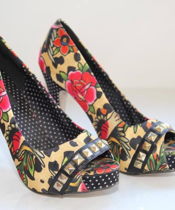 Vibrant floral high heels with studded accents and polka dot interior, perfect for fashion-forward women and special occasions.