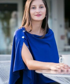 Elegant woman in a royal blue dress sitting outdoors, showcasing stylish fashion for women, modern casual wear, and sophisticated summer outfit ideas for women.