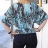 Vibrant blue and black abstract printed kimono top, stylish women's fashion, casual yet chic, perfect for summer or spring outfits, with a relaxed fit.