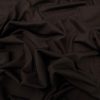 Silky black fabric with soft folds, luxurious textile material, smooth and elegant draping, high-quality cloth for fashion or home decor, photographed close-up for detailed texture visibility.