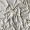 Soft white fabric with gentle folds, ideal for sewing, quilting, and crafting projects. High-quality, natural textile perfect for creating clothing, home decor, or artistic designs.
