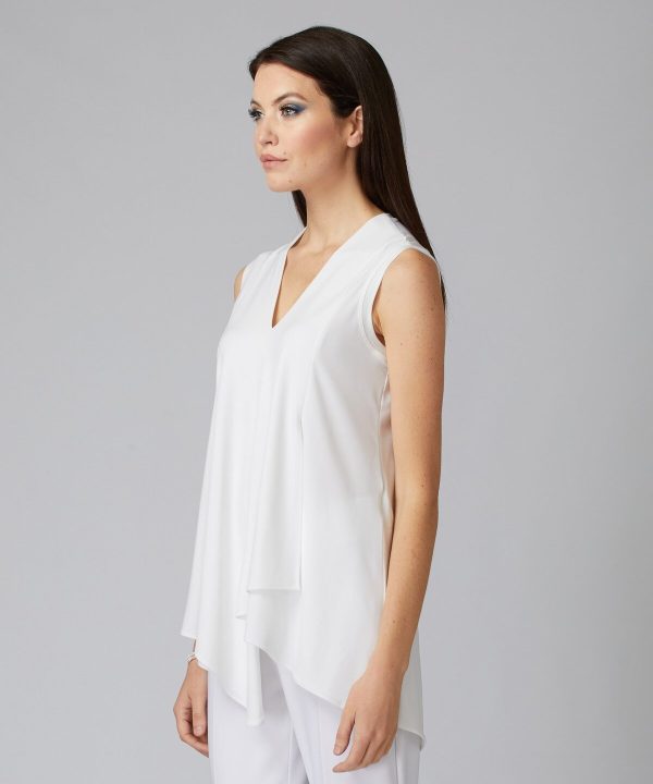 Elegant white sleeveless blouse with V-neck and draped front, perfect for sophisticated and modern fashion looks, as showcased by a stylish model.