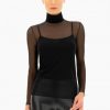 Sleek black mesh turtleneck top with long sleeves and fitted style, perfect for fashion-forward women, layered over a black camisole, paired with shiny black leather pants, ideal for modern chic outfits, stylish and versatile women’s clothing.