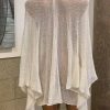 Delicate beige crochet shawl on a mannequin, showcasing handwoven fashion accessory for boho and summer style.