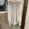 Luxurious beige knit shawl or wrap displayed on a mannequin, designed for warmth and style, perfect for fall and winter fashion accessories.