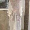Lightweight white sheer kaftan with bell sleeve details, perfect for beachwear or summer occasions.