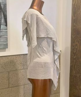 Light beige woven knit lightweight cardigan layered over a white top, displayed on a mannequin. Perfect for casual or beachwear, emphasizing comfort and style for warm weather outfits.