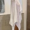 Elegant white knitted shawl or wrap displayed on a dress form, perfect for fashion, styling, or accessory use. Ideal for adding a chic layer to any outfit.