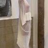 Luxurious white knitted cardigan displayed on a mannequin, perfect for cozy winter fashion and stylish layering.