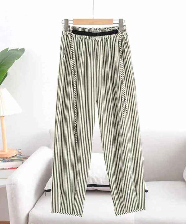 Striped high-waisted wide-leg pants with black elastic waistband, stylish and comfortable women's fashion, perfect for casual or office wear, displayed on a hanger in a modern minimalist setting.