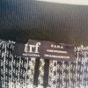 Black and white checkered skirt tag details, showcasing Zara TRF collection label and size 28, made in Romania, with high-quality knitted fabric, ideal for stylish casual wear.