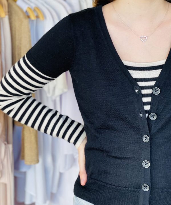 Knitted black cardigan with striped long sleeve shirt underneath, stylish women's fashion, casual layered outfit, fall and winter apparel, modern chic clothing, boutique clothing store, women’s casual cardigan, layered look for women, comfortable and trendy style, fabric details of knitwear.