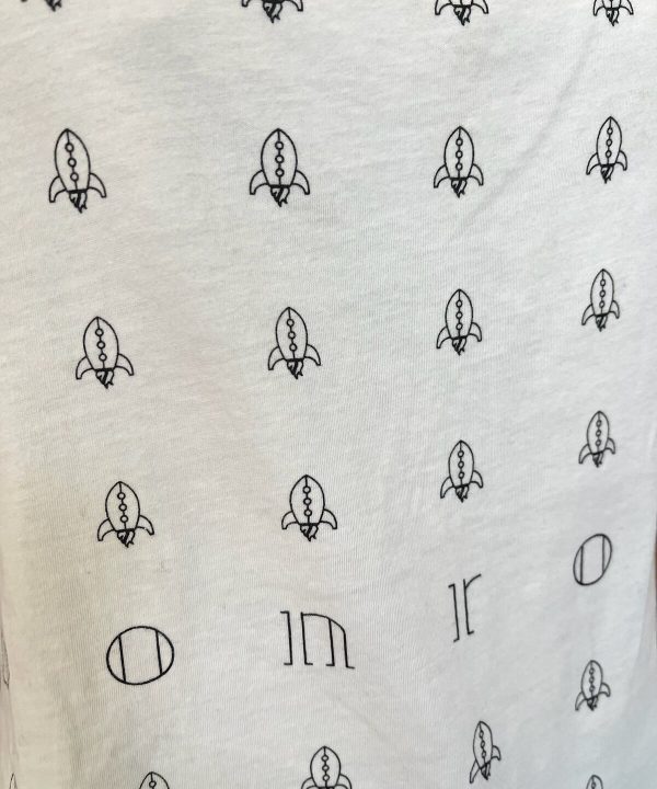 Rocket pattern fabric with minimalist black line drawings of rockets for custom sewing projects and crafts.