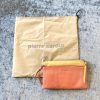 High-end Pierre Cardin leather clutch bag in peach pink with yellow accents, featuring multiple compartments, stylish design, and premium craftsmanship. Perfect for elegant and versatile accessories.