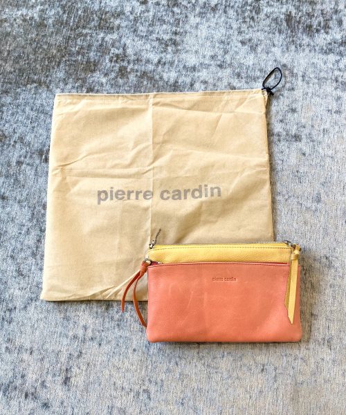 High-end Pierre Cardin leather clutch bag in peach pink with yellow accents, featuring multiple compartments, stylish design, and premium craftsmanship. Perfect for elegant and versatile accessories.