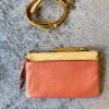 Leather crossbody bag with adjustable strap, soft pink and yellow colorblock, stylish and functional for everyday use, handmade artisan accessories.