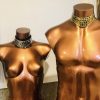 Shiny metallic mannequin torsos with gold and bronze finish showcasing jewelry displays for jewelry, fashion accessories, jewelry display mannequins for designer jewelry, artistic jewelry presentation, modern jewelry showcase design.