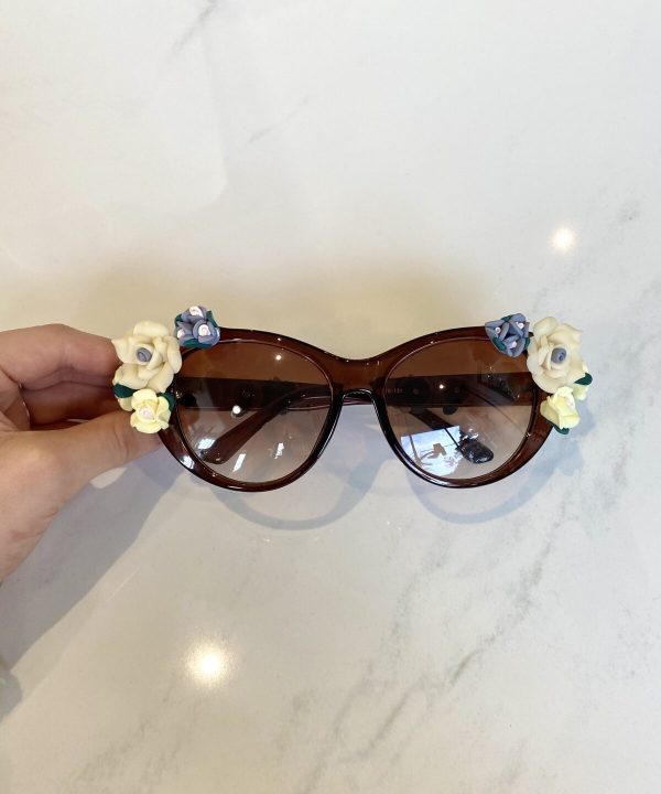 Fashion sunglasses with floral embellishments, brown tinted lenses, stylish accessories for women, summer eyewear, designer sunglasses.