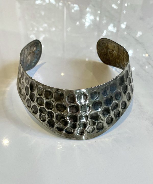 Polished silver statement cuff bracelet with a textured hexagonal pattern artisan jewelry handmade jewelry.