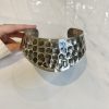 Hammered silver cuff bracelet with textured honeycomb pattern, artisan jewelry piece, handcrafted silver jewelry, unique metallic accessory, modern designer cuff.