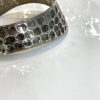 Hexagon patterned silver cuff bracelet, modern jewelry design, stylish accessory for women.