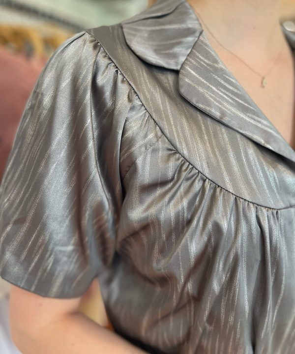 Shiny metallic blouse with puff sleeves and a collar, featuring elegant, pleated fabric detail for stylish women’s fashion. Perfect for chic, trendy outfits and special occasions.