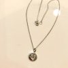 Silver initial pendant necklace with delicate chain and lobster clasp, perfect for personalized jewelry and gift-giving processes.