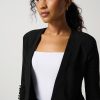 Elegant African American woman in business attire, black blazer and white top, professional headshot for corporate, fashion, or lifestyle purposes.