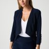 Elegant navy blue blazer with pearl-button details, perfect for professional or chic occasions, styled with a white V-neck top, creating a sophisticated and timeless look.