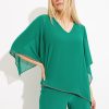 Flattering emerald green women's blouse with flowing batwing sleeves and silver embroidery details, perfect for elegant summer or evening wear.