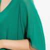 Luxurious emerald green dress with flowing fabric and elegant black piping details, perfect for sophisticated events and evening wear.