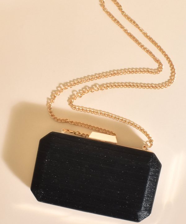 Elegant black evening clutch purse with a textured finish and gold-tone chain strap. Perfect for formal occasions, evening events, or night outs, adding a touch of sophistication to any outfit.