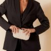 Elegant women's black blazer and tailored pants with pearl-embellished clutch, showcasing sophisticated fashion and accessories by katyamaker for chic styling.