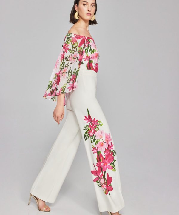 Vibrant floral designer outfit featuring a pink and green botanical print on a flowy top and wide-leg pants, perfect for spring and summer fashion statements.