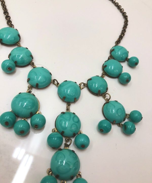 Turquoise statement necklace with large round beads and gold-tone chain, boho chic jewelry, handmade jewelry, vibrant jewelry accessory, trendy jewelry piece.