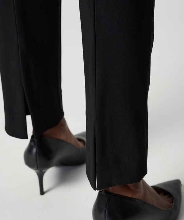 Elegant black high heels paired with tailored black pants, showcasing sophisticated women's fashion and professional style. Perfect for formal or business occasions.