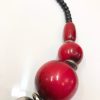 Bright red and black beaded handmade necklace with metal accents, showcasing unique jewelry design, perfect for statement accessory lovers, from katyamaker’s custom jewelry collection.