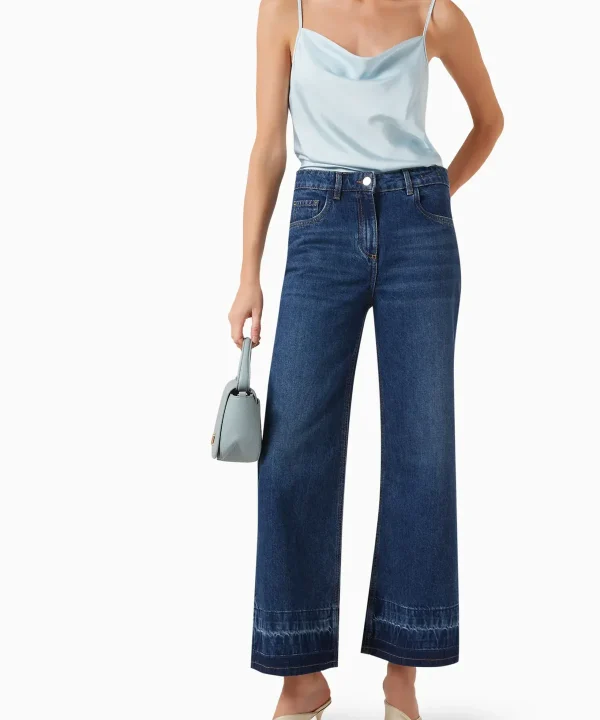 Relaxed fit wide-leg denim jeans with high waist and raw hem, pair with stylish satin camisole for casual or chic outfits.