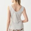 White sleeveless V-neck top for women, versatile summer blouse, stylish casual sleeveless top, feminine fitted tank top, elegant warm-weather top for women.