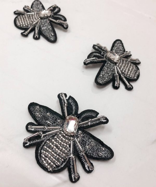 Black and silver bee embroidered patches with rhinestones, perfect for embellishing clothing or accessories, handmade jewelry, and craft projects.