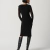 Elegant black midi dress with sheer long sleeves, perfect for stylish evening wear and special occasions.