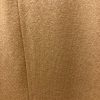 Soft beige knitted fabric texture in close-up.