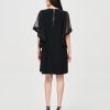 Elegant black dress with sheer sleeve detailing, back zipper closure, perfect for stylish events and evening wear.