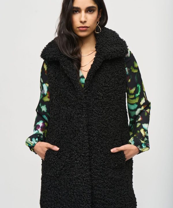 Cozy black fleece vest layered over a vibrant floral dress, showcasing stylish fall and winter fashion trends for women. Perfect for casual wear and outdoor adventures.