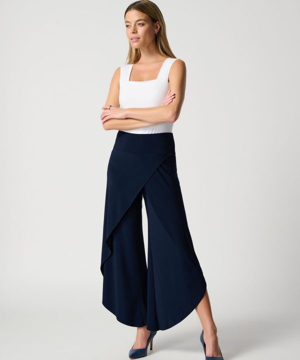 Flowy navy blue wide-leg pants and white sleeveless top with square neckline, stylish modern women's fashion, elegant professional look, Katyamaker interior design inspiration.