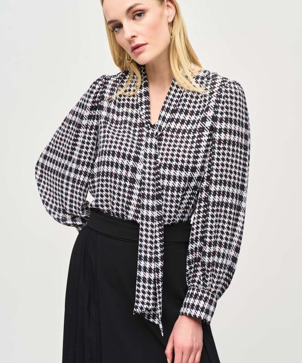 Katyamaker women’s black and white houndstooth patterned blouse with tie front detail, long sleeves, stylish and versatile for office or casual wear.