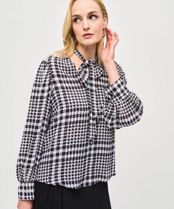Elegant houndstooth blouse with tie-neck detail, perfect for fall fashion and stylish office wear.